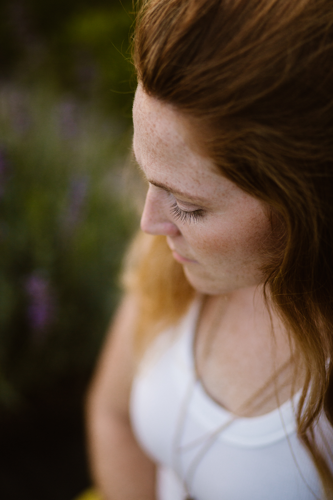 Red headed woman in yellow skirt at sunset in a lavender field.